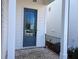 Close-up of a modern front door with a glass window, set in a brick-paved entryway of a new home at 635 Skytop Dr, Cumming, GA 30040