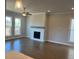 Spacious living room showcasing hardwood floors, neutral walls, large windows and a decorative fireplace at 635 Skytop Dr, Cumming, GA 30040