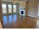 Spacious living room showcasing hardwood floors, neutral walls, large windows and a decorative fireplace at 635 Skytop Dr, Cumming, GA 30040