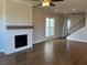 Spacious living room with hardwood floors, fireplace, and staircase at 635 Skytop Dr, Cumming, GA 30040