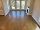 Bright living room featuring hardwood floors, three large windows, and a fireplace at 635 Skytop Dr, Cumming, GA 30040