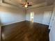 Main bedroom with hardwood floors, tray ceiling, and ceiling fan at 635 Skytop Dr, Cumming, GA 30040