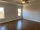 Large bedroom with hardwood floors, tray ceiling, and many windows at 635 Skytop Dr, Cumming, GA 30040