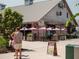 The Cattle Shed restaurant exterior with metal roof, outdoor patio seating, and event signage at 635 Skytop Dr, Cumming, GA 30040