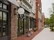 Retail shops along a sidewalk feature storefronts, signage, and decorative planters enhancing curb appeal at 635 Skytop Dr, Cumming, GA 30040