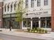 Street view of retail shops with awnings and decorative lighting; Avenue of the Oaks home and gift shop at 635 Skytop Dr, Cumming, GA 30040