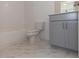 Bathroom with gray vanity, white subway tile, and marble floor at 631 Silva St # 129, Cumming, GA 30040