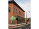 Brick building with green mural and black framed windows at 631 Silva St # 129, Cumming, GA 30040