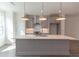 Modern kitchen island with white countertop and gray cabinets at 631 Silva St # 129, Cumming, GA 30040