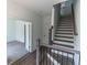 Modern staircase with dark wood railings and grey flooring at 631 Silva St # 129, Cumming, GA 30040