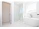 Bathroom featuring standalone tub, walk-in shower, and marble floors at 362 Olmstead Way # 23, Alpharetta, GA 30002