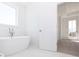 Bathroom featuring standalone tub, open doorway to bedroom, and tile floors at 362 Olmstead Way # 23, Alpharetta, GA 30002