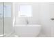 Modern bathroom featuring a soaking tub and glass-enclosed shower at 362 Olmstead Way # 23, Alpharetta, GA 30002