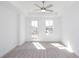 Spacious bedroom features large windows, ceiling fan, and neutral carpet at 362 Olmstead Way # 23, Alpharetta, GA 30002