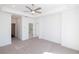 Open bedroom featuring a ceiling fan, plush carpet, and bright white walls at 362 Olmstead Way # 23, Alpharetta, GA 30002