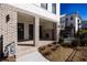 Charming brick home with a covered front porch, black-framed windows and manicured landscaping at 362 Olmstead Way # 23, Alpharetta, GA 30002