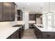 Modern kitchen featuring stainless steel appliances, a kitchen island, and dark wood cabinets at 362 Olmstead Way # 23, Alpharetta, GA 30002