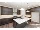 Modern kitchen featuring stainless steel appliances, a kitchen island, and dark wood cabinets at 362 Olmstead Way # 23, Alpharetta, GA 30002