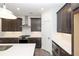 Modern kitchen boasts dark cabinets, stainless steel appliances, and quartz countertops at 362 Olmstead Way # 23, Alpharetta, GA 30002