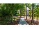 Scenic view of a walking path leading to townhouses surrounded by tall trees at 362 Olmstead Way # 23, Alpharetta, GA 30002