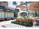 Exterior of a restaurant with an outdoor patio area, lush greenery, and stylish awnings at 362 Olmstead Way # 23, Alpharetta, GA 30002