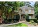 Elegant two-story home featuring a stone facade, upper balcony, and beautifully landscaped front yard at 1632 Brookhaven Close Ne, Brookhaven, GA 30319