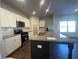Modern kitchen with white cabinets, granite countertops, and stainless steel appliances at 4555 Sweetlake Ct, Mableton, GA 30126