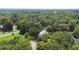 Aerial view of house nestled in lush trees and open fields at 5809 Warren Farm Sw Rd, Powder Springs, GA 30127