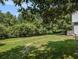 Large grassy backyard with mature trees and privacy at 5809 Warren Farm Sw Rd, Powder Springs, GA 30127