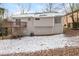 View of the back of the house with a wooden deck and a snowy yard at 2920 Cushing Ct, Jonesboro, GA 30236