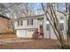 Gray house with wooden stairs and a two-car garage, surrounded by trees at 2920 Cushing Ct, Jonesboro, GA 30236