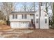 Two-story house with attached two-car garage and wooden stairs leading to the front entrance at 2920 Cushing Ct, Jonesboro, GA 30236