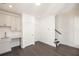 Fully finished basement features a wet bar with modern white cabinetry and dark floors at 352 Olmstead Way # 28, Alpharetta, GA 30022