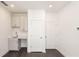 Brightly lit basement space featuring a wet bar with white cabinets and stylish flooring at 352 Olmstead Way # 28, Alpharetta, GA 30022