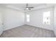 Spacious bedroom featuring plush gray carpeting, two bright windows, and modern ceiling fan at 352 Olmstead Way # 28, Alpharetta, GA 30022