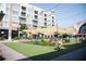 Outdoor area with seating under shaded canopies, with string lights and retail stores in the background at 352 Olmstead Way # 28, Alpharetta, GA 30022