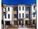 Attractive townhome featuring a mix of brick and siding under a clear blue sky at 352 Olmstead Way # 28, Alpharetta, GA 30022
