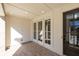 Beautiful front porch with a brick floor, elegant trim and glass doors at 352 Olmstead Way # 28, Alpharetta, GA 30022