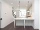 Bright, modern kitchen features white cabinets, quartz countertops and an island with counter seating at 352 Olmstead Way # 28, Alpharetta, GA 30022
