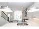 Bright, modern kitchen features white cabinets, quartz countertops, stainless-steel appliances and staircase nearby at 352 Olmstead Way # 28, Alpharetta, GA 30022