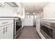 A modern kitchen with white cabinets, stainless steel appliances, and hardwood floors for a sleek, modern design at 352 Olmstead Way # 28, Alpharetta, GA 30022
