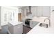 Bright, modern kitchen features white cabinets, stainless-steel appliances and a quartz countertop island at 352 Olmstead Way # 28, Alpharetta, GA 30022