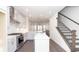 Open-concept kitchen with stainless steel appliances and a kitchen island, seamlessly connected to a staircase at 352 Olmstead Way # 28, Alpharetta, GA 30022