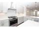 Modern kitchen features white cabinets, quartz countertops, stainless steel appliances and range hood at 352 Olmstead Way # 28, Alpharetta, GA 30022