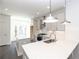 Bright, modern kitchen features white cabinets, quartz countertops and stainless-steel appliances at 352 Olmstead Way # 28, Alpharetta, GA 30022