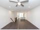 Spacious living room showcasing hardwood floors, a ceiling fan, and a clear view into the modern kitchen at 352 Olmstead Way # 28, Alpharetta, GA 30022