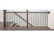 Modern staircase with dark wood railings and black iron spindles, providing an elegant transition between levels at 352 Olmstead Way # 28, Alpharetta, GA 30022
