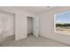 Bedroom with closet and window, featuring neutral wall colors and carpet at 12014 Conrad Cir, Hampton, GA 30228