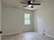 Bright bedroom featuring modern ceiling fan, window view, and light gray vinyl flooring at 14 Saint Claire Ne Ln, Atlanta, GA 30324