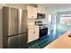 Modern kitchen featuring stainless steel appliances, white cabinetry, and unique checkered flooring at 14 Saint Claire Ne Ln, Atlanta, GA 30324